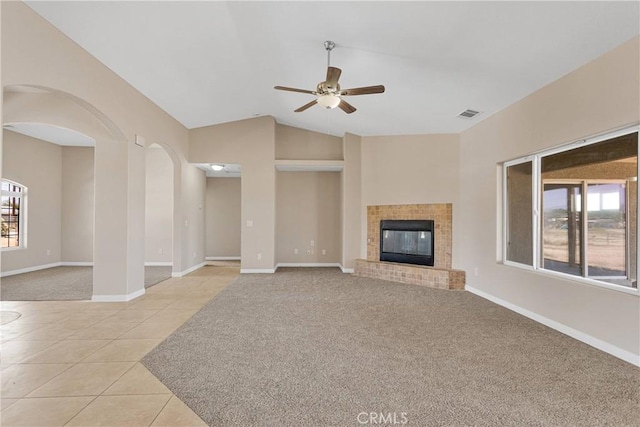 11569 Arroyo Ave, Hesperia, CA 92345 - unfurnished living room with light carpet, ceiling fan, light tile patterned floors, vaulted ceiling, and baseboards