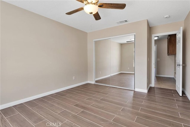 11569 Arroyo Ave, Hesperia, CA 92345 - unfurnished bedroom featuring wood tiled floors, baseboards, a closet, and a ceiling fan