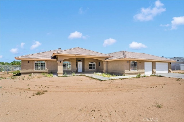 11569 Arroyo Ave, Hesperia, CA 92345 - mediterranean / spanish house with a tile roof, stucco siding, and driveway