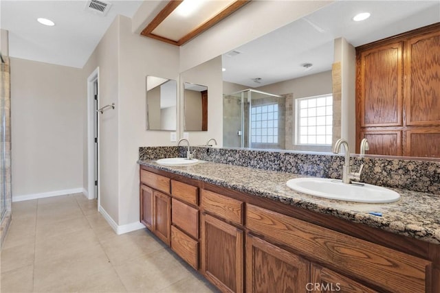 11569 Arroyo Ave, Hesperia, CA 92345 - full bathroom featuring a stall shower, double vanity, tile patterned floors, and baseboards