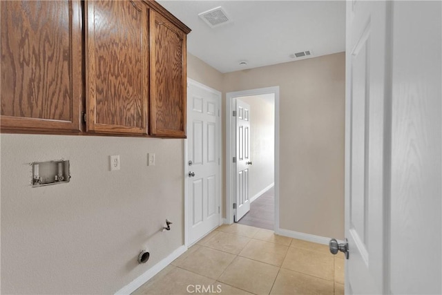 11569 Arroyo Ave, Hesperia, CA 92345 - laundry area featuring cabinet space, baseboards, hookup for a washing machine, and light tile patterned flooring