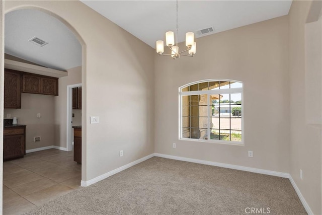 11569 Arroyo Ave, Hesperia, CA 92345 - empty room with a chandelier, light colored carpet, arched walkways, and baseboards