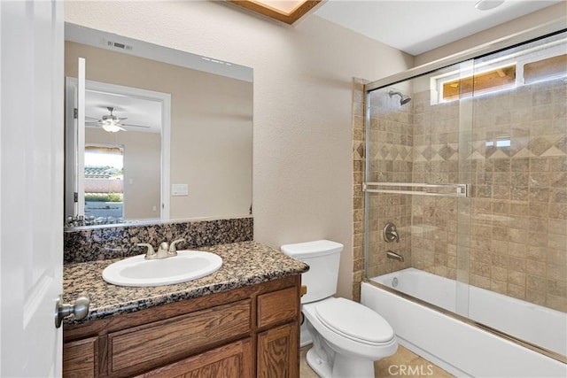 11569 Arroyo Ave, Hesperia, CA 92345 - bathroom with vanity, toilet, enclosed tub / shower combo, and a ceiling fan