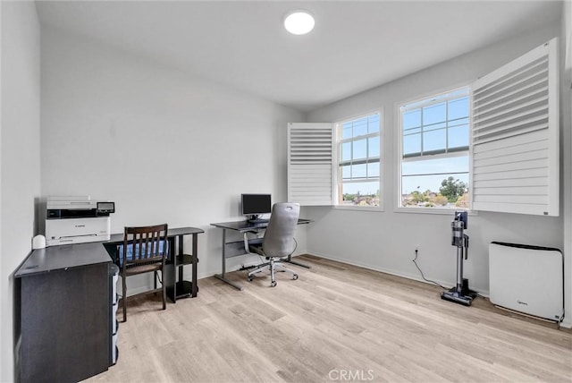 office area with light wood finished floors and baseboards