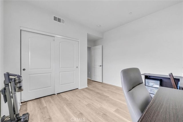office space with visible vents and light wood-style flooring