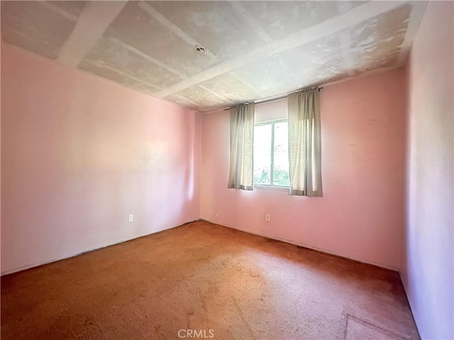 unfurnished room featuring light carpet