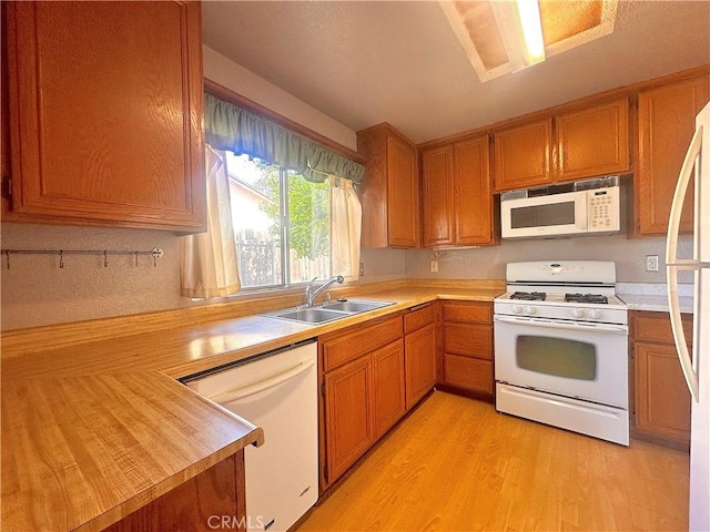 14585 Long View Dr, Fontana, CA 92337 - kitchen with white appliances, a sink, light countertops, and light wood-style floors