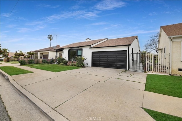 ranch-style house featuring a front lawn, stucco siding, a gate, an attached garage, and driveway