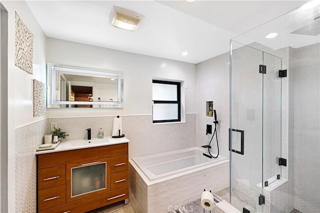 full bath featuring vanity, a bath, visible vents, and a shower stall