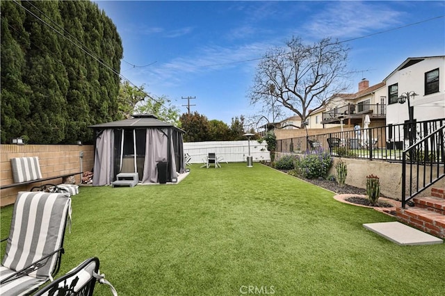 view of yard with a gazebo and a fenced backyard