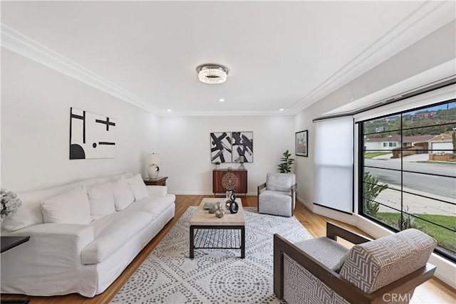 living room featuring crown molding, recessed lighting, plenty of natural light, and light wood-type flooring