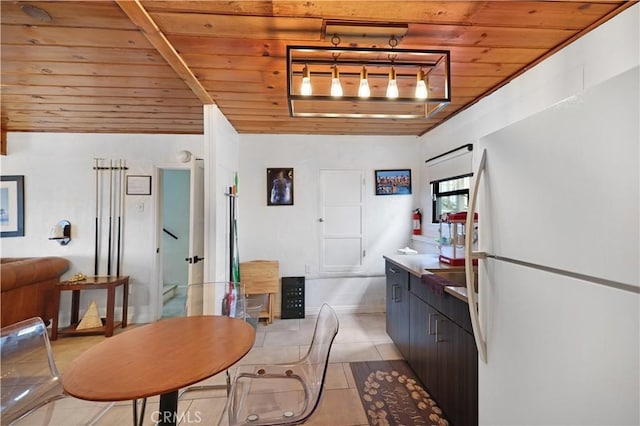 dining area with light tile patterned flooring and wooden ceiling