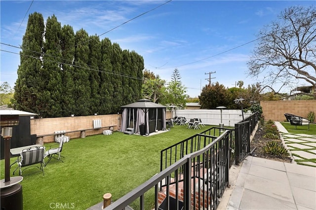 view of yard featuring a gazebo and a fenced backyard