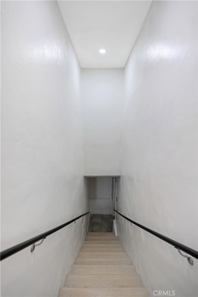 stairway featuring recessed lighting and wood finished floors