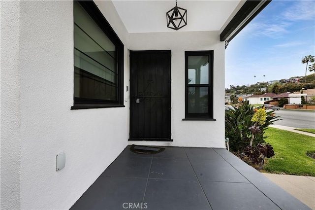 entrance to property featuring stucco siding