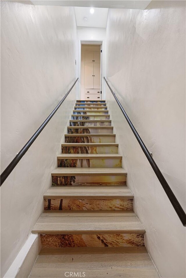 staircase with recessed lighting