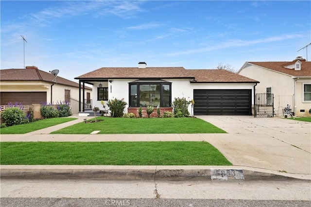 ranch-style home with concrete driveway, an attached garage, a front yard, and stucco siding