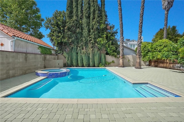 view of swimming pool featuring a fenced backyard, a patio area, and a pool with connected hot tub