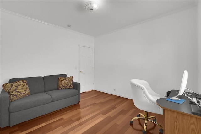 office area featuring baseboards, ornamental molding, and wood finished floors