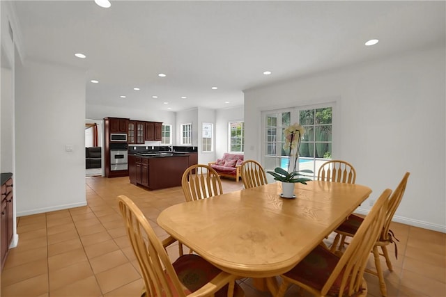 dining area featuring recessed lighting, baseboards, and light tile patterned floors