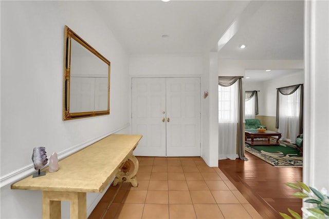 foyer with recessed lighting and light tile patterned floors