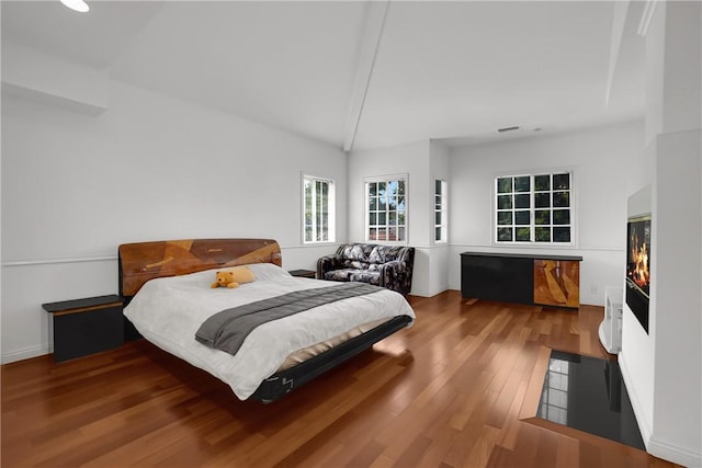 bedroom featuring vaulted ceiling and wood finished floors