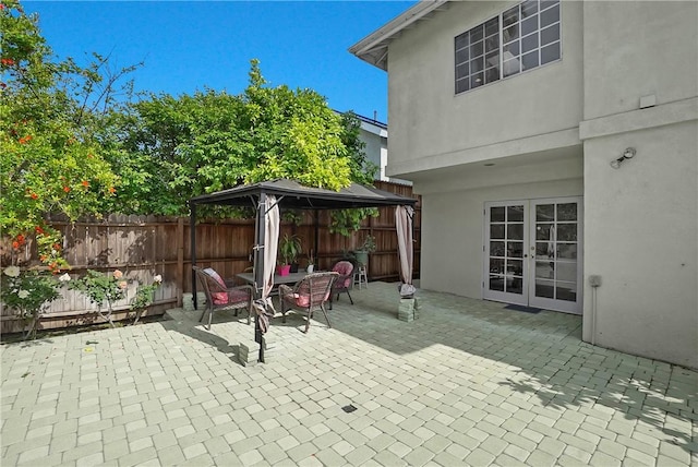 view of patio / terrace with a gazebo, fence, and french doors