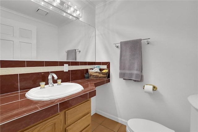 half bath with tile patterned flooring, decorative backsplash, vanity, ornamental molding, and toilet
