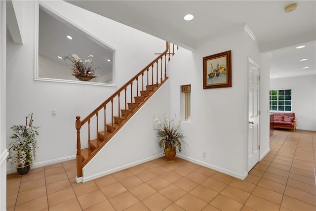 stairway with recessed lighting, baseboards, and tile patterned flooring