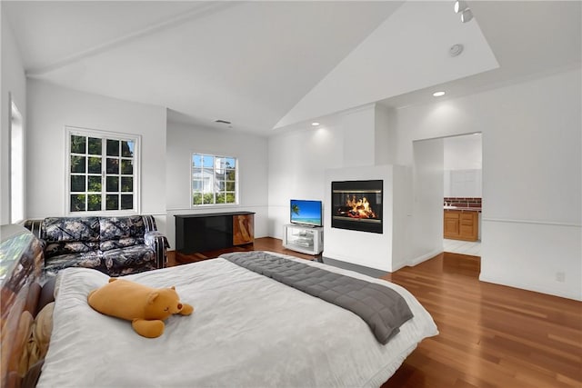 bedroom featuring a multi sided fireplace, high vaulted ceiling, recessed lighting, and wood finished floors