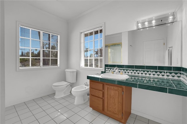 bathroom with tile patterned flooring, a bidet, toilet, and vanity
