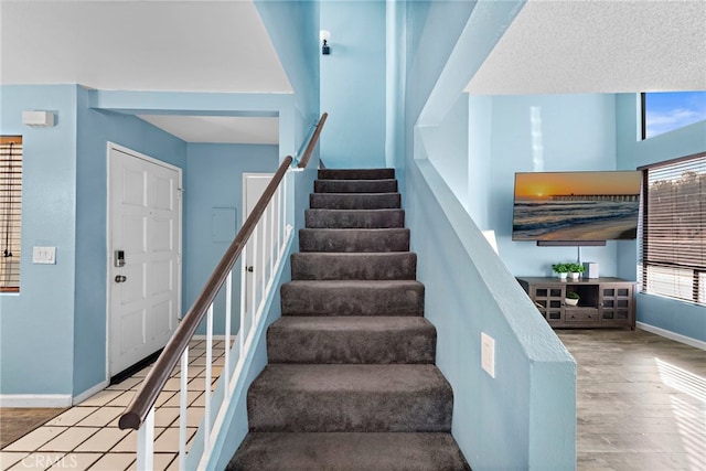 950 W Lambert Rd Unit 9, La Habra, CA 90631 - stairway featuring baseboards and wood finished floors