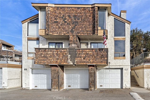 950 W Lambert Rd Unit 9, La Habra, CA 90631 - townhome / multi-family property with aphalt driveway, a balcony, stucco siding, a chimney, and an attached garage