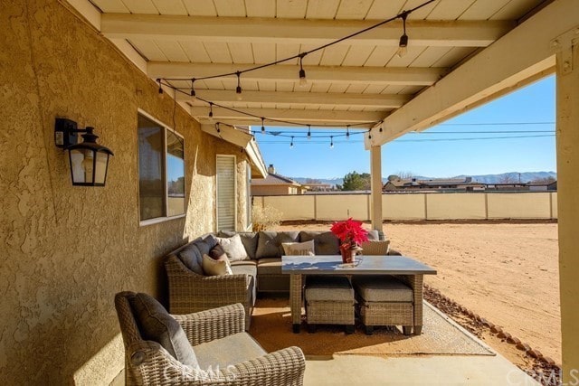 view of patio / terrace with fence and an outdoor living space