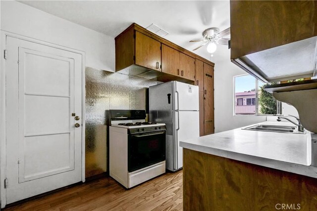 305 Raymondale Dr Unit L, South Pasadena, CA 91030 - kitchen featuring wood finished floors, a ceiling fan, a sink, brown cabinetry, and white appliances