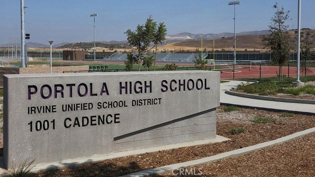 community sign featuring fence and a mountain view