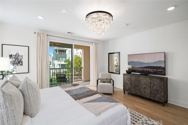 bedroom featuring visible vents, wood finished floors, access to outside, recessed lighting, and a notable chandelier