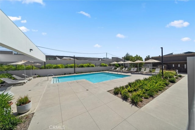 pool with fence and a patio