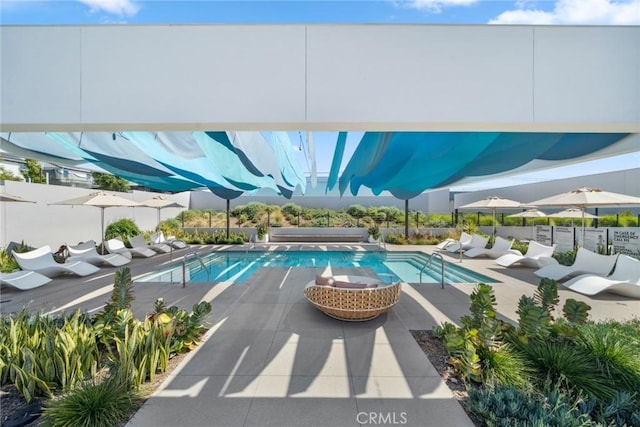 view of swimming pool featuring a fenced in pool and a patio area