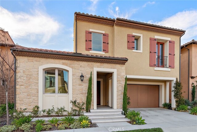 215 Sutters Ml, Irvine, CA 92602 - mediterranean / spanish house with concrete driveway, an attached garage, stone siding, and stucco siding