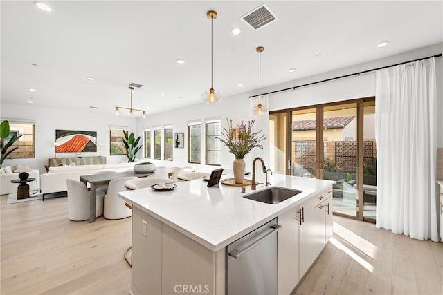 215 Sutters Ml, Irvine, CA 92602 - kitchen featuring a sink, visible vents, light wood finished floors, and dishwasher