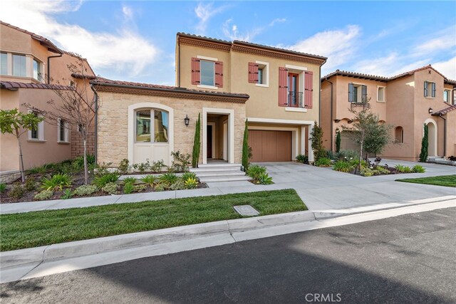 215 Sutters Ml, Irvine, CA 92602 - mediterranean / spanish-style house featuring a tile roof, a garage, concrete driveway, stone siding, and stucco siding