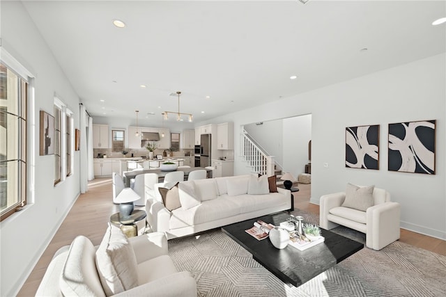 215 Sutters Ml, Irvine, CA 92602 - living area with recessed lighting, light wood-style flooring, baseboards, and stairway