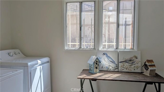 washroom featuring laundry area, independent washer and dryer, and a wealth of natural light