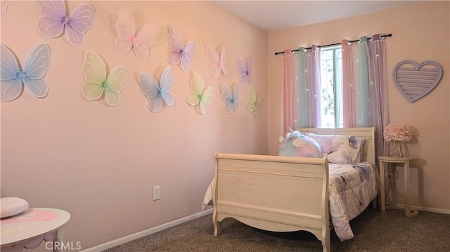 carpeted bedroom featuring baseboards