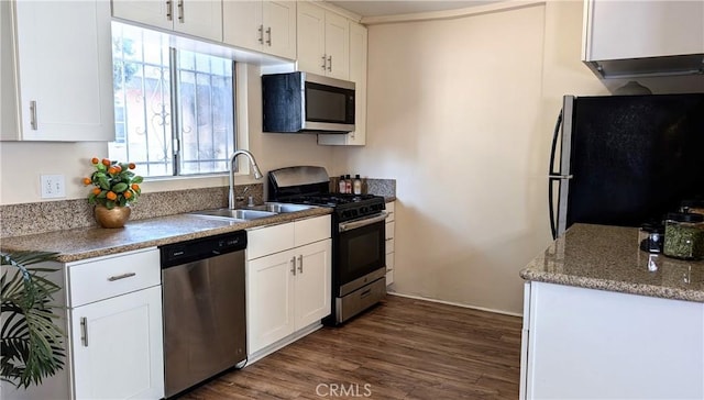kitchen featuring a sink, stainless steel appliances, dark wood-style flooring, and white cabinetry
