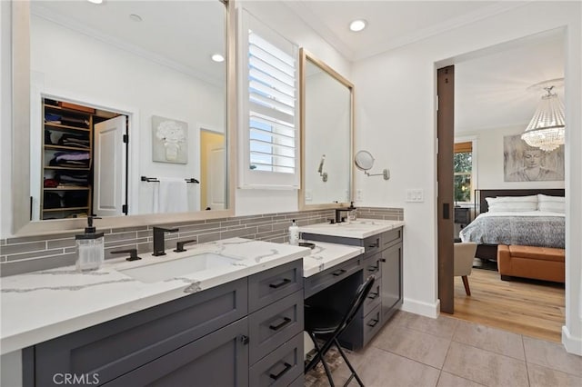 full bathroom featuring vanity, tile patterned floors, ensuite bathroom, tasteful backsplash, and ornamental molding