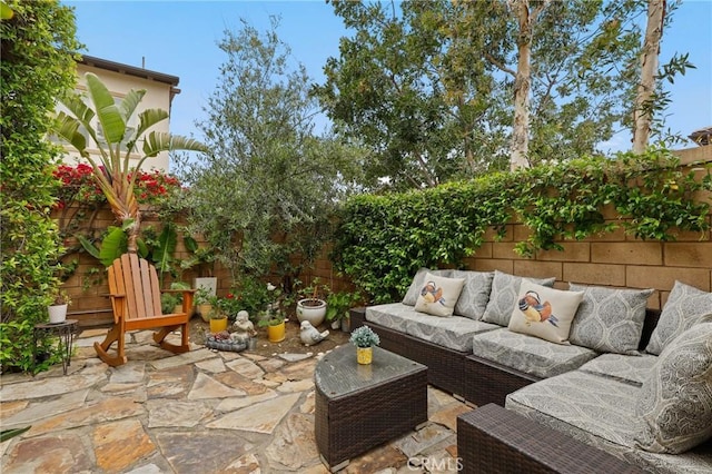 view of patio featuring an outdoor living space and a fenced backyard