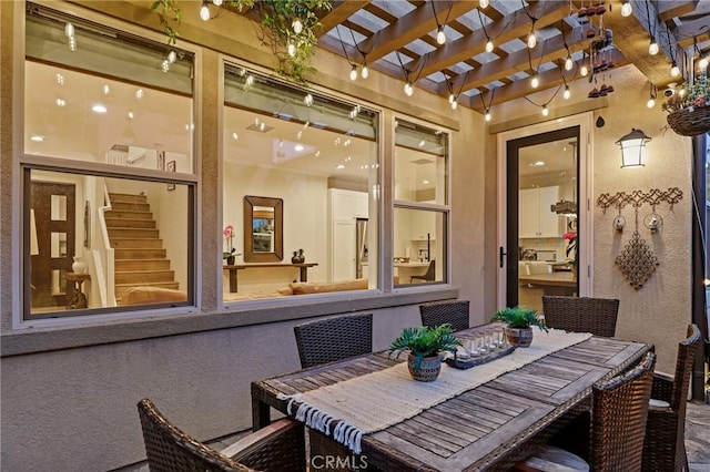 exterior space with a pergola and outdoor dining area