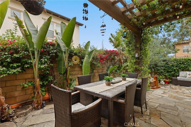 view of patio featuring a pergola, outdoor dining area, and a fenced backyard